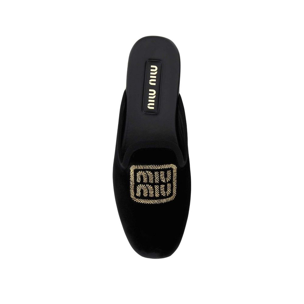 Mules Miu Miu en cuir de veau noir