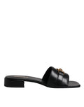 Sandales plates Versace en cuir noir avec plaque logo